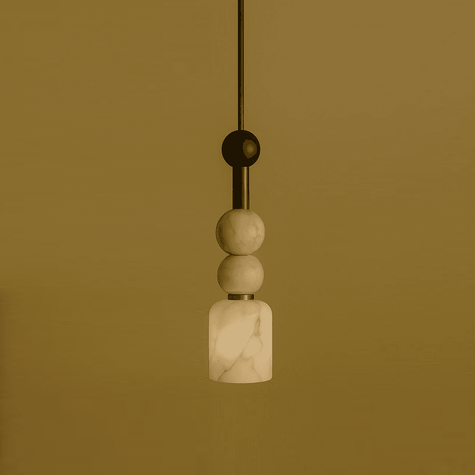 Alabaster beaded pendant light with two stone beads above a lit cylinder shade on a brass stem