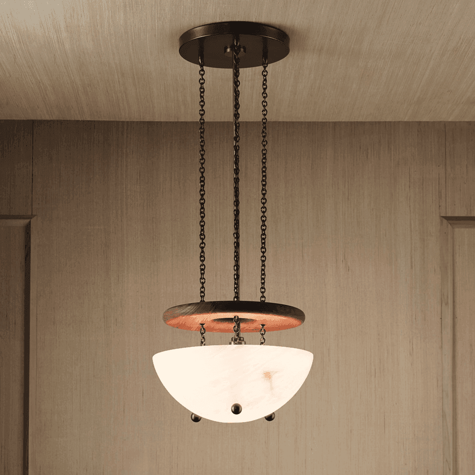 Alabaster bowl chandelier lit warm, hand-cut stone uplight bowl below a walnut ring on bronze chains