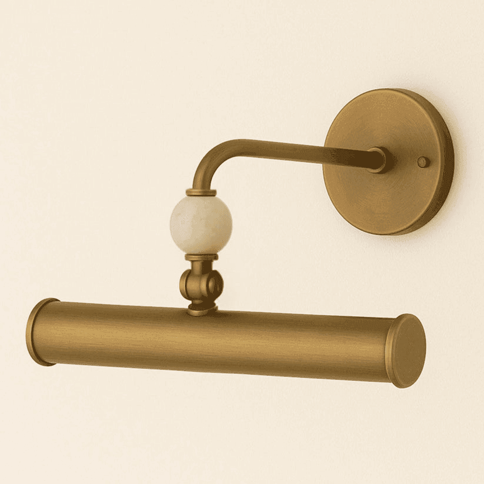 Brass picture light with a natural stone ball joint and curved antique brass arm