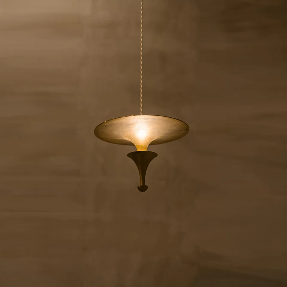Brass Uplight Pendant Light – 300 mm Indirect LED Disc | Jagmag Lights 3 Brass uplight pendant light glowing against a warm plaster wall