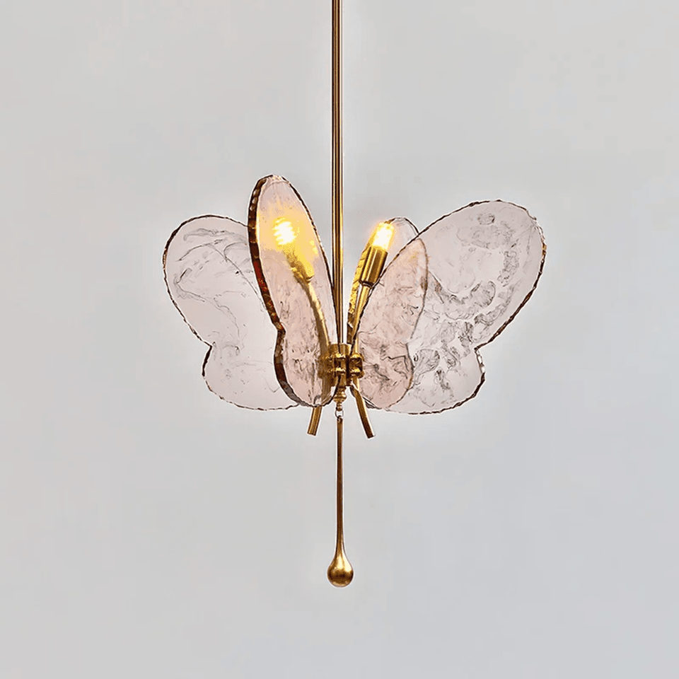 Butterfly Pendant Light – Marbled Glass Wings on Brass, 49 cm | Pink or Blue | Jagmag Lights 5 Angled view of a lit pink butterfly pendant light with brass teardrop finial - Jagmag Lights
