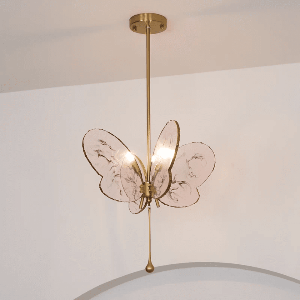 Butterfly Pendant Light – Marbled Glass Wings on Brass, 49 cm | Pink or Blue | Jagmag Lights 8 Pink butterfly pendant light hanging from a brass canopy against a pale wall - Jagmag Lights