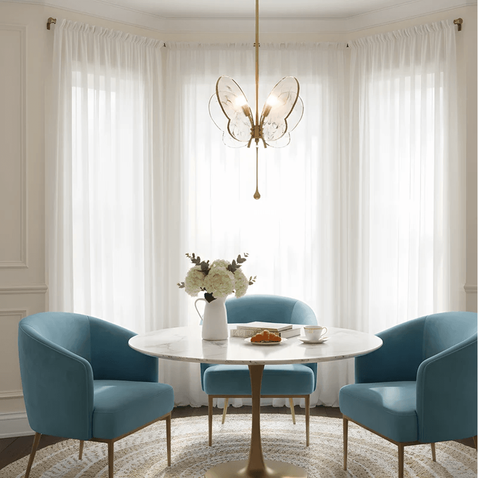 Butterfly Pendant Light – Marbled Glass Wings on Brass, 49 cm | Pink or Blue | Jagmag Lights 9 Pink butterfly pendant light above a round marble table in a bay window - Jagmag Lights