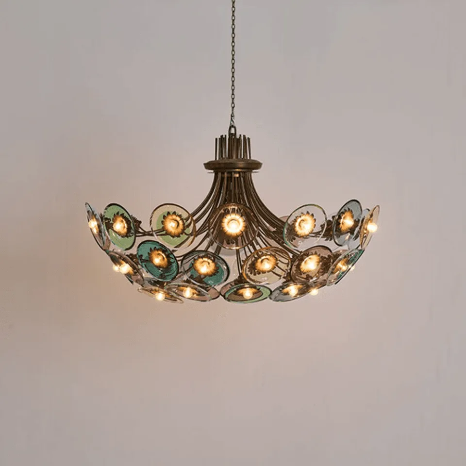 Coloured glass chandelier lit, 28 glass discs glowing in green, blue and amethyst