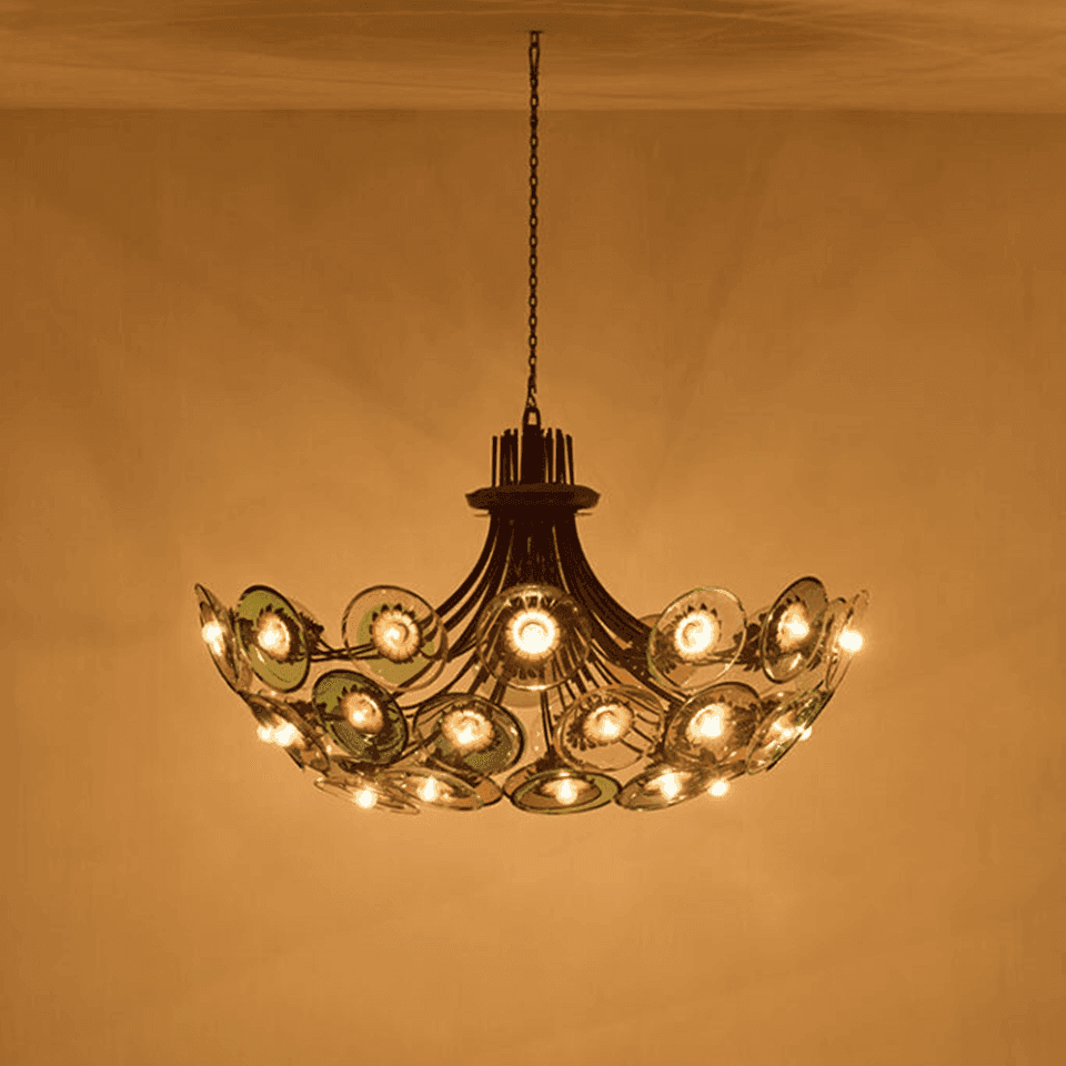 Coloured Glass Chandelier – 4 ft Brass Bowl with 6″ Glass Discs | Jagmag Lights 3 Coloured glass chandelier lit against a golden wall, colour cast across the ceiling