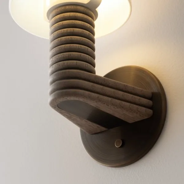 Wooden wall sconce backplate detail, wood arm turning off a round 304 stainless steel plate in antique bronze finish