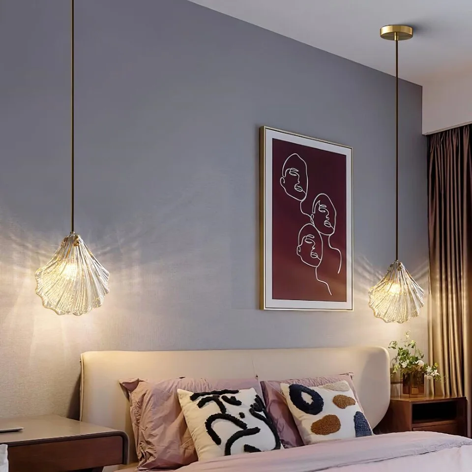 Glass Leaf Pendant Light – Clear Ribbed Glass with Brass, G9 3 A pair of glass leaf pendant lights hanging either side of a bed as bedside lighting