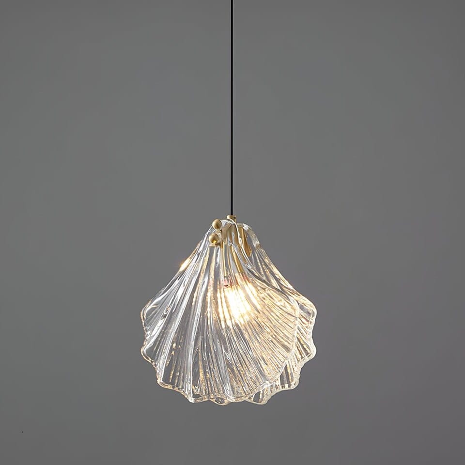 Clear ribbed glass leaf pendant light with brass fittings lit warm