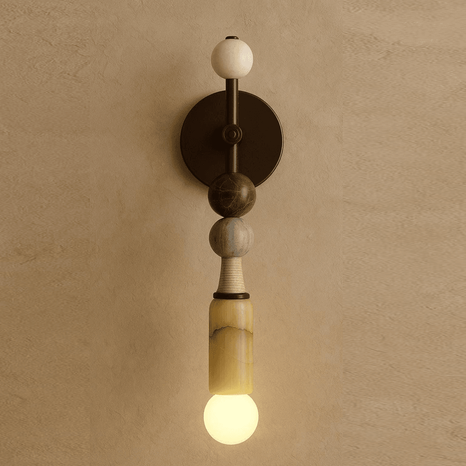 Honey alabaster wall light lit, four stacked stones on a dark bronze plate