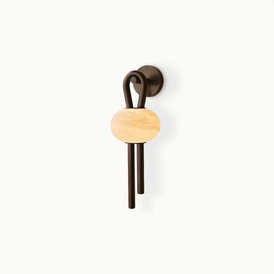 Oval alabaster wall light lit warm, hand-cut stone in a looped antique bronze arm with twin drop rods