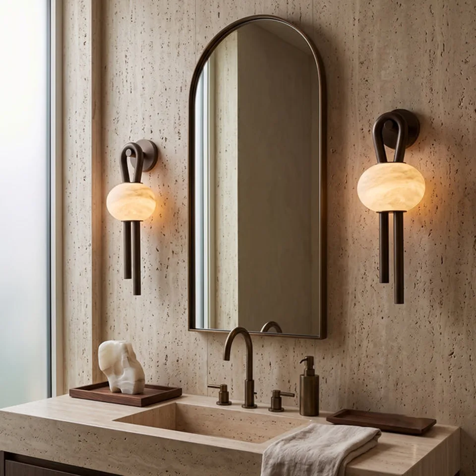 Oval Alabaster Wall Light – 53 cm Natural Stone & Bronze | Jagmag Lights 5 Pair of oval alabaster wall lights flanking an arched bathroom vanity mirror on travertine