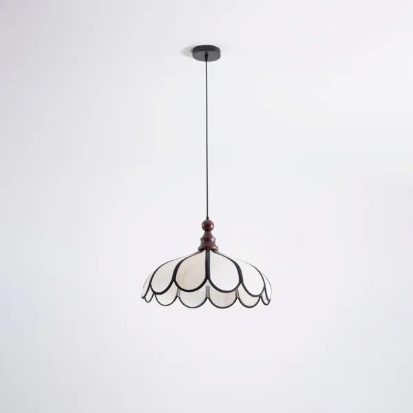 Full drop of the scalloped fabric pendant light from a round black ceiling canopy on a black cord