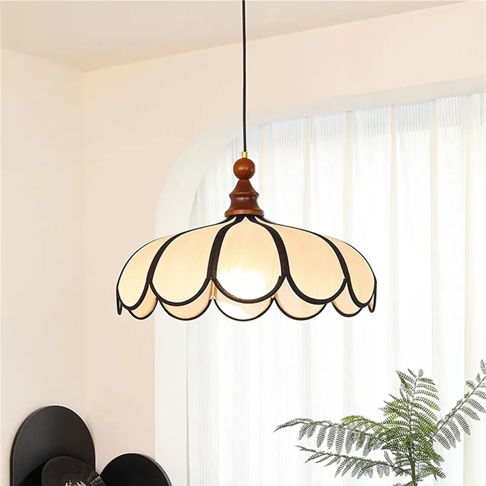Scalloped Fabric Pendant Light – Ivory Petals, Black Trim and Wood Finial, 50 cm 9 Scalloped fabric pendant light glowing in a living room beside sheer white curtains
