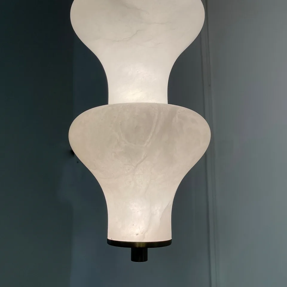 Sculptural Alabaster Pendant Light – 65 cm Stacked Stone | Jagmag Lights 4 Close-up of alabaster veining lit from within against a teal wall