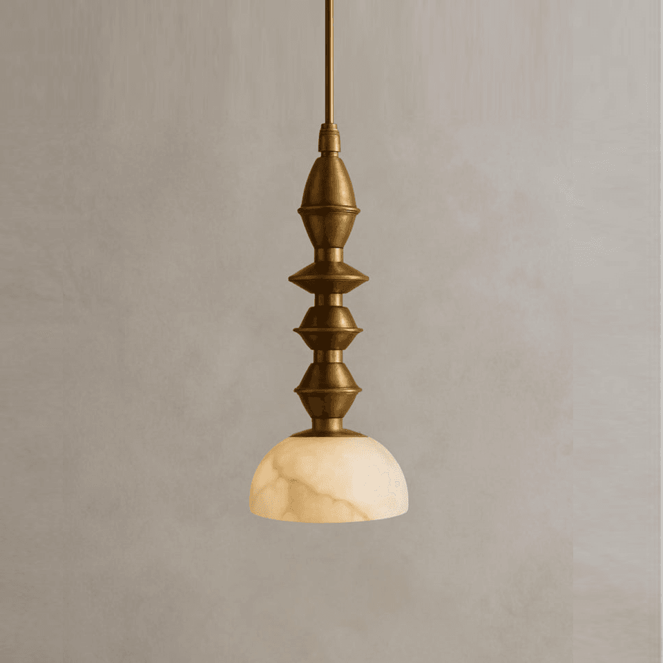 Turned brass pendant light with a four-part spindle above a cream alabaster dome