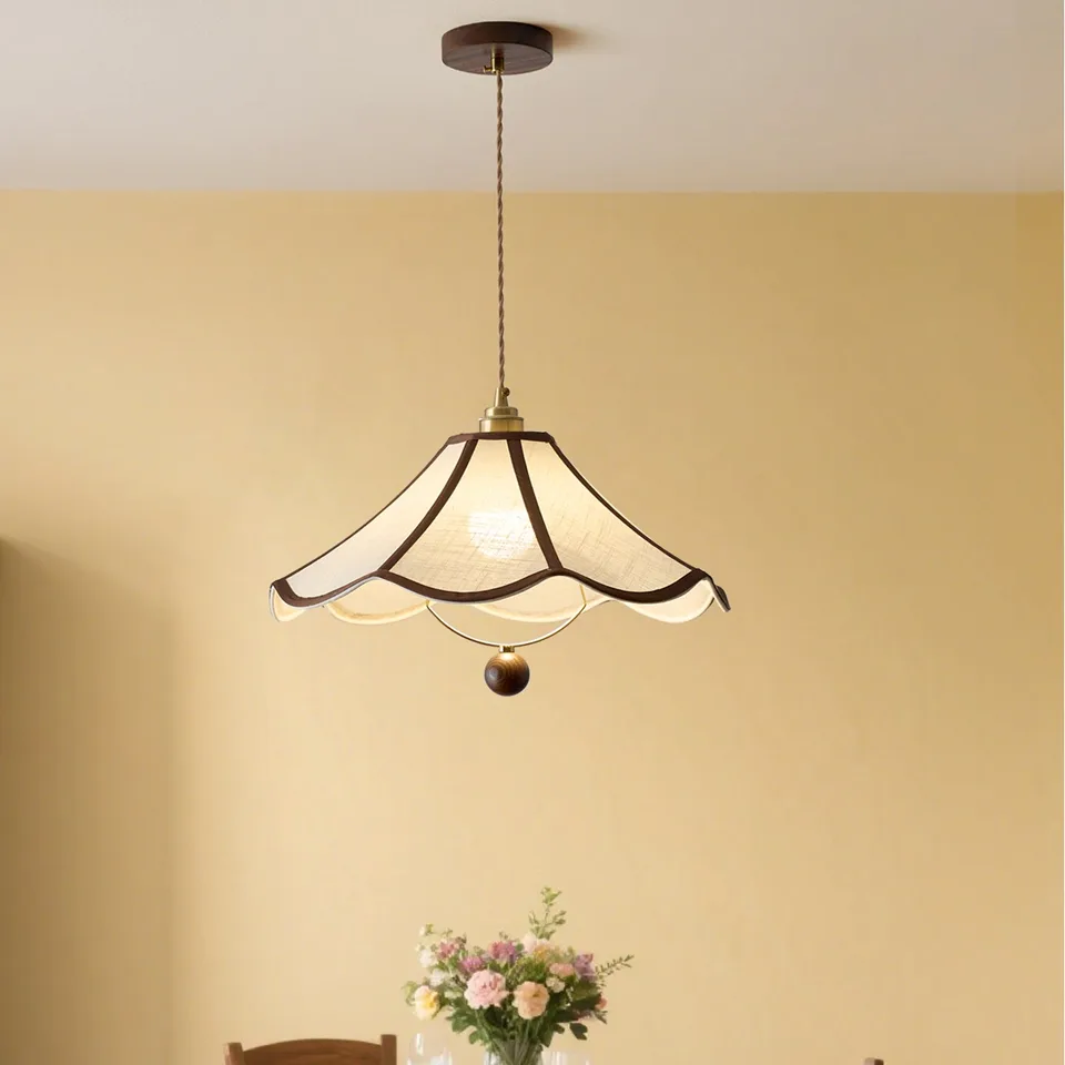 Umbrella Fabric Pendant Light – Wavy Shade, Brown Trim & Wood Ball Drop, 40 cm | Jagmag Lights 6 Umbrella fabric pendant light lit above a dining table against a warm yellow wall - Jagmag Lights