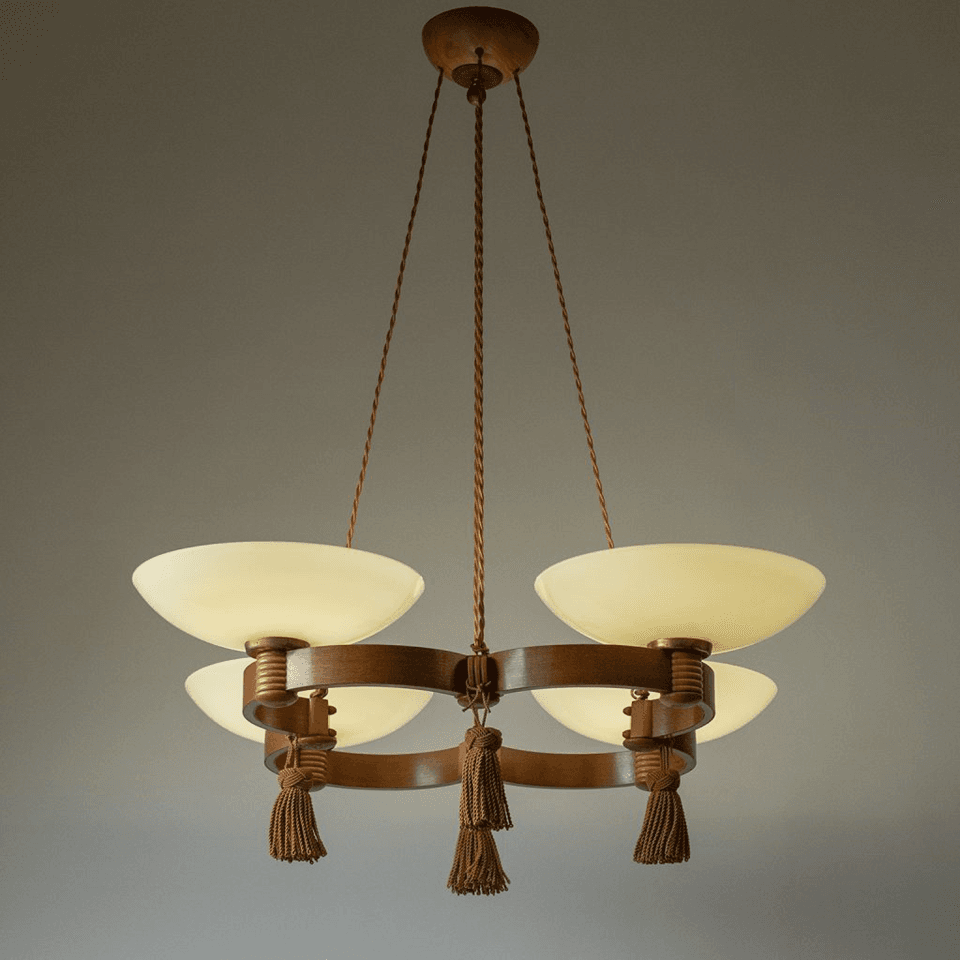 Wood and glass chandelier lit, four opal glass bowls glowing on a double wooden ring
