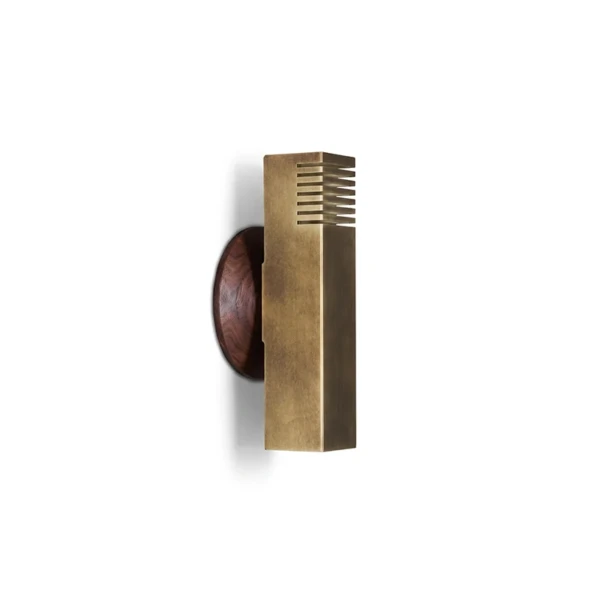 Boundary wall light with a walnut wood backplate on a white wall, three-quarter view