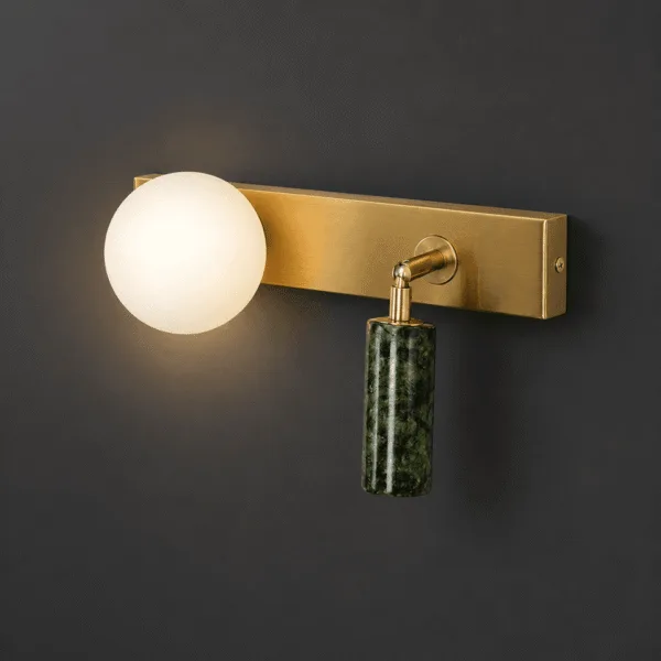 Green wall light lit warm on a dark wall: glowing opal borosilicate glass globe beside the green jade stone cylinder