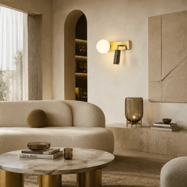 Green wall light glowing warm on a plaster wall in a calm living room with a curved sofa and an arched niche