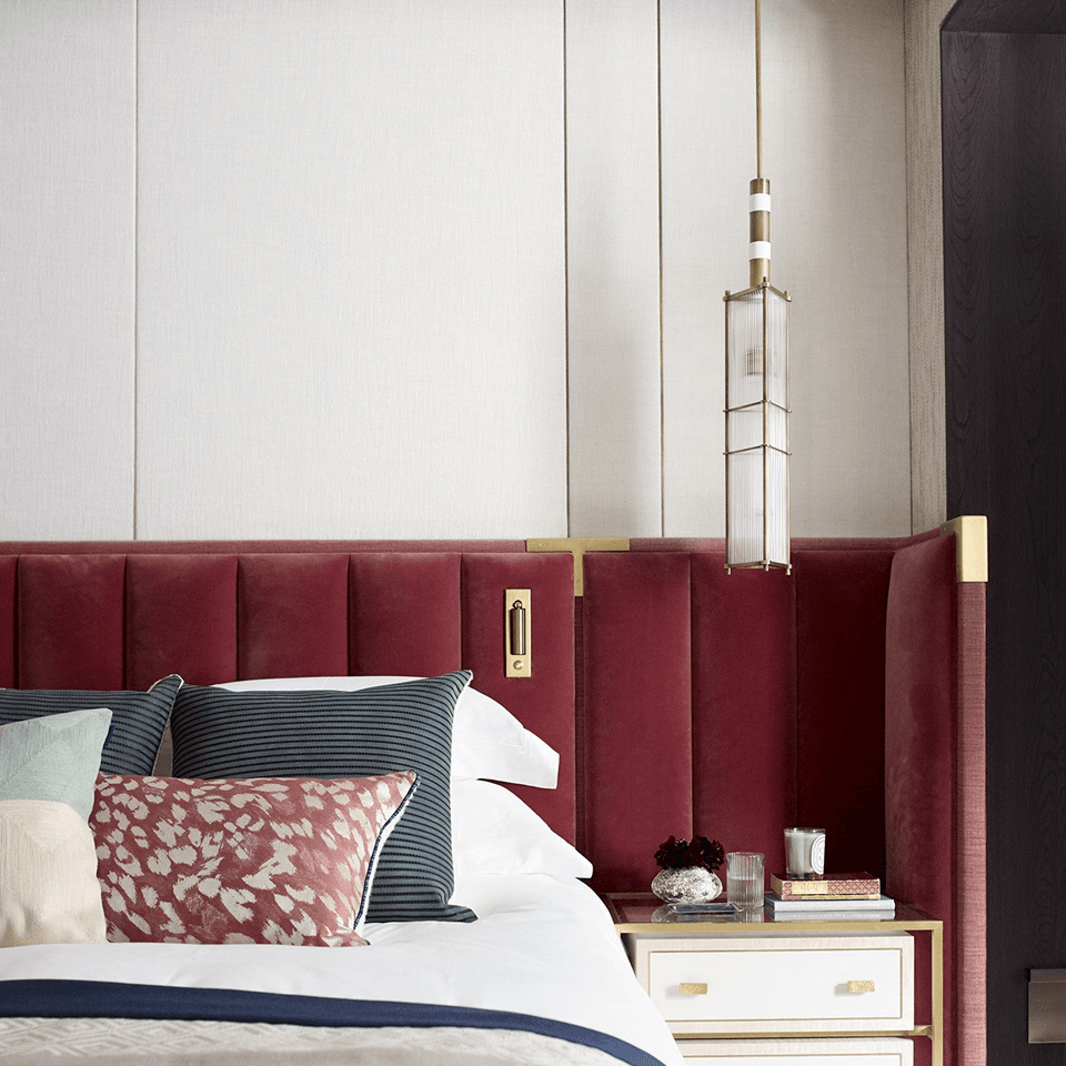 Reeded Glass Lantern Pendant – Brass Cage, 75 cm | Jagmag Lights 5 Antique-brass reeded glass lantern pendant beside a bed with a red velvet headboard