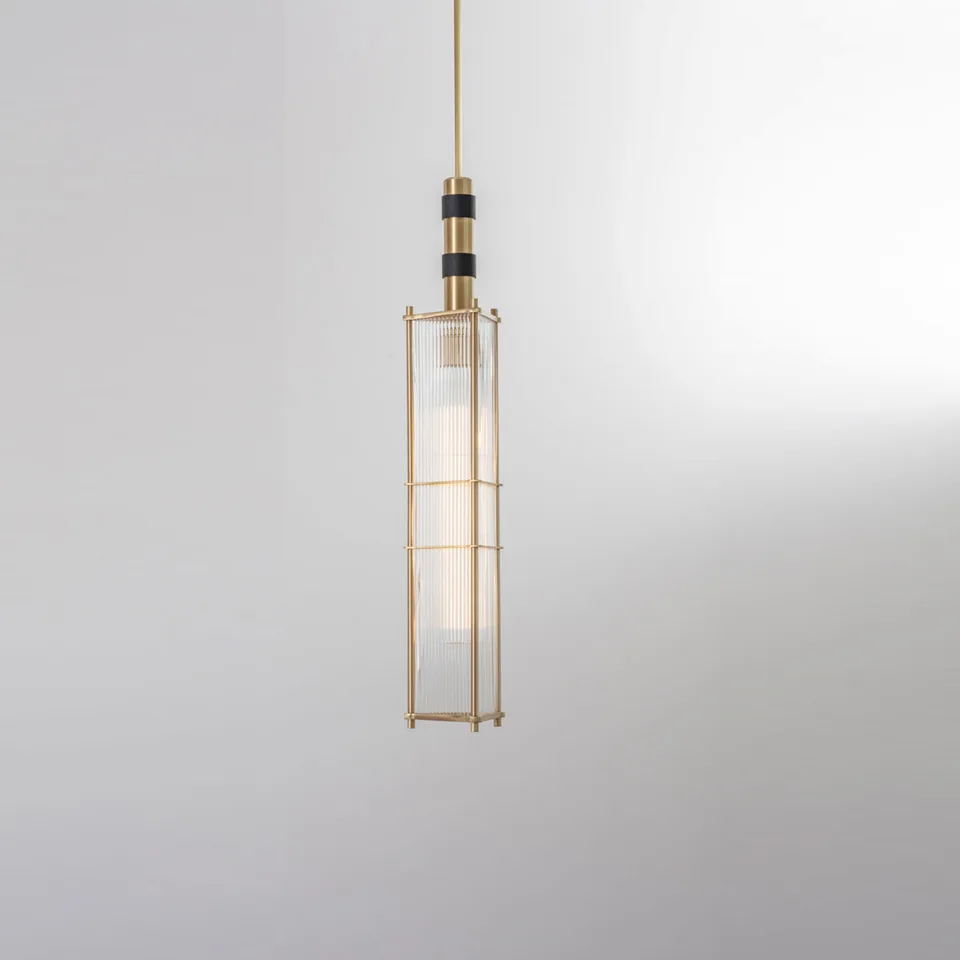 Reeded glass lantern pendant in satin brass with black accent bands, tall rectangular cage of fluted glass