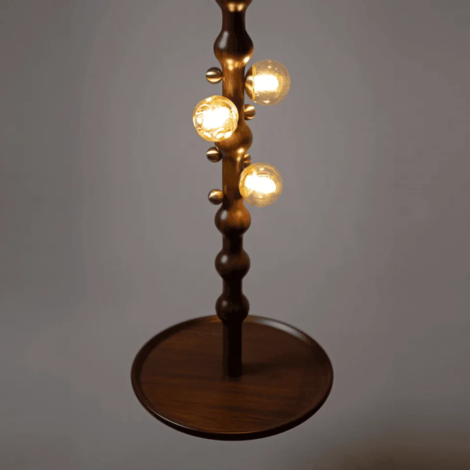Stem Pendant Light – Sculpted Reclaimed Teak with Amber Glass Globes & Side Table | Jagmag Lights 3 Close-up of the three amber glass globes and brass accents on the teak stem of the Stem pendant light