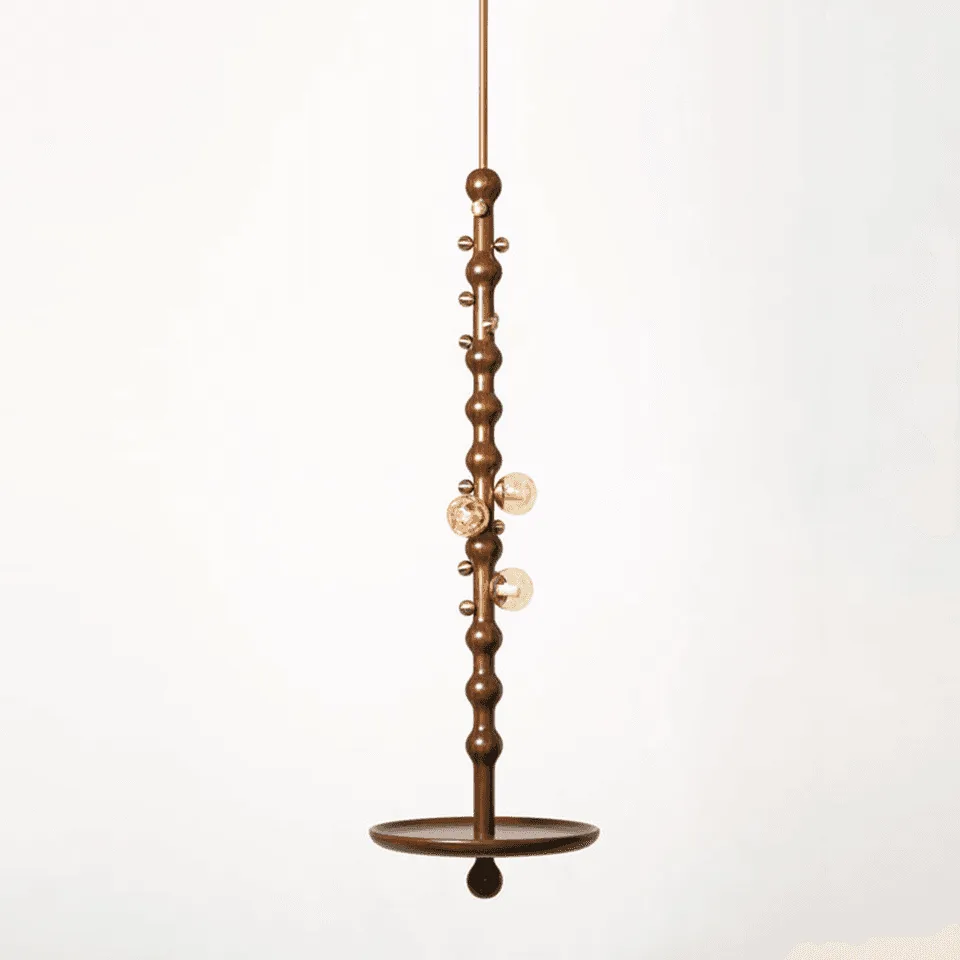 Stem pendant light on a white background — sculpted reclaimed-teak stem with brass details, three amber glass globes and a circular teak side-table plate