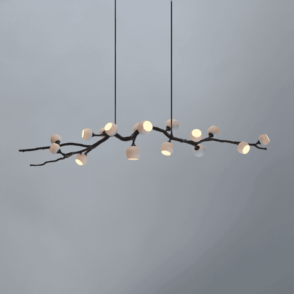 Twig chandelier lit, blackened branch carrying opal glass cups at varied angles