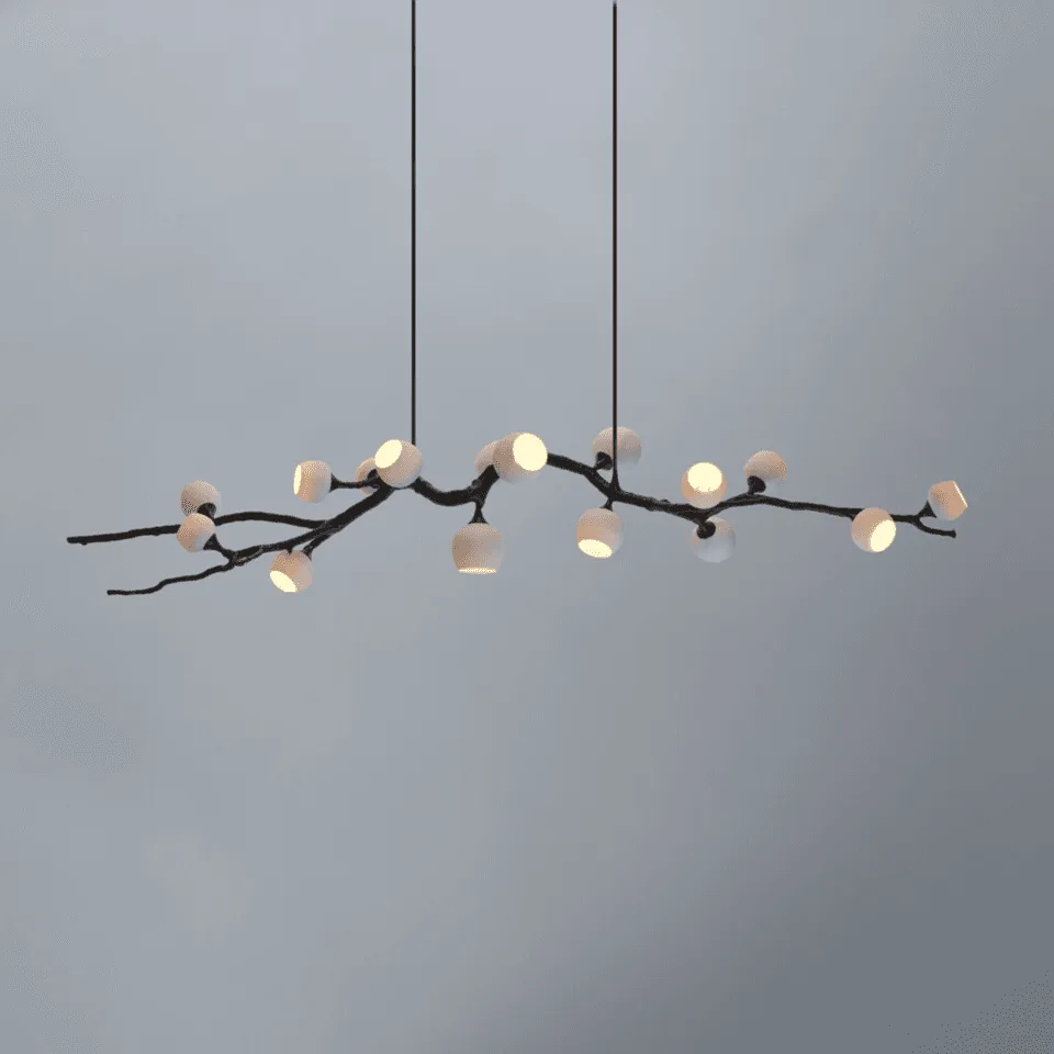 Twig chandelier lit, blackened branch carrying opal glass cups at varied angles