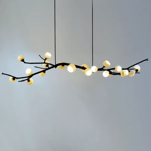 Twig chandelier lit warm, glass cups glowing along the full 5 ft branch
