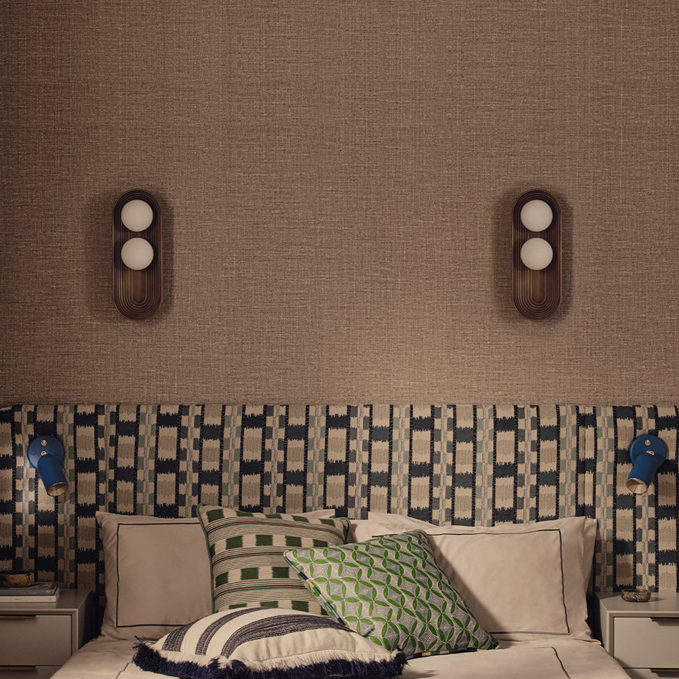 Twin Oval Wall Light – Reeded Wood & Opal Glass, Matt Gold or Bronze | Jagmag Lights 4 Two antique-bronze twin oval wall lights flanking a bed above a patterned headboard