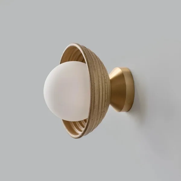 Wood wall light three-quarter view with the opal borosilicate glass ball facing forward from the reeded gold dome