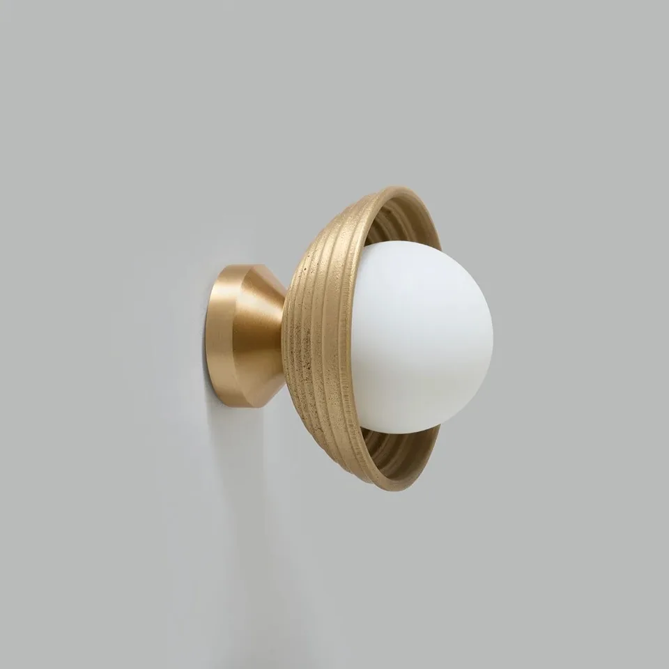 Wood Wall Light – Reeded Matt-Gold Dome & Opal Glass Ball, 16 cm | Jagmag Lights 2 Wood wall light with a reeded matt-gold dome and lit opal borosilicate glass ball, side view on a grey wall