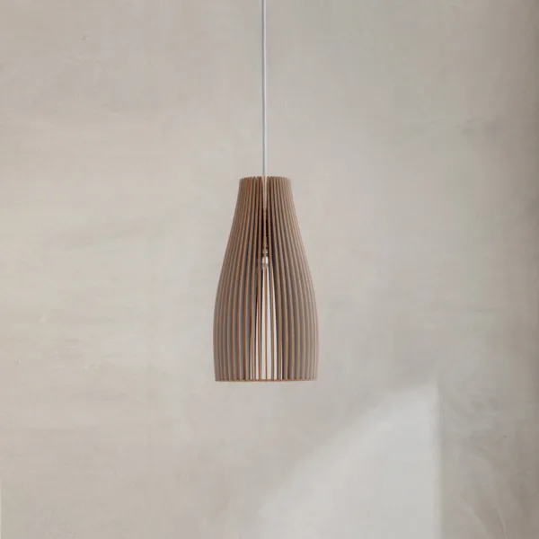 Wooden hanging light with a slatted birch plywood teardrop shade on a white cord against a plaster wall
