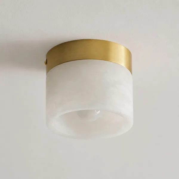 Alabaster cylinder and brushed brass-finish canopy seen at an angle