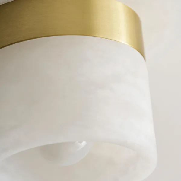 Close-up of polished alabaster and the brass-finish canopy