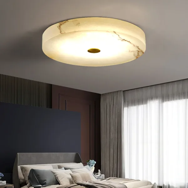Alabaster ceiling light glowing above a bed in a low-ceiling bedroom