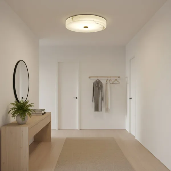 Round alabaster flush mount light in an entrance passage