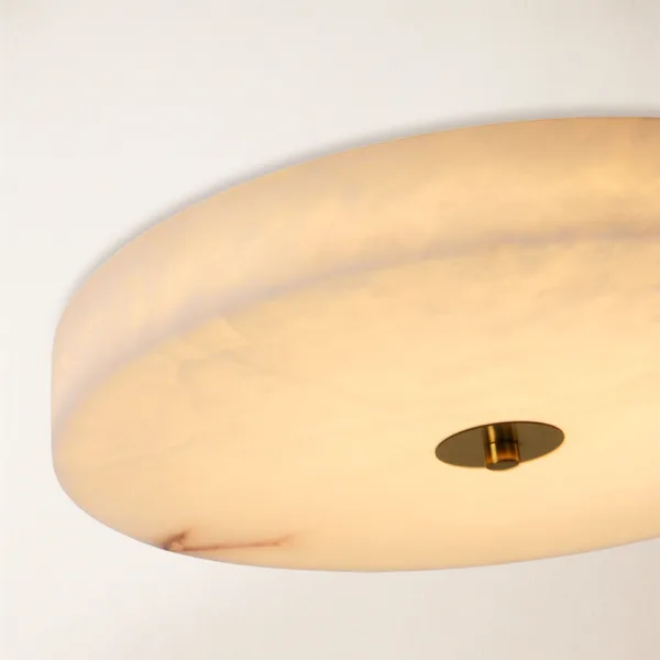 Close-up of light glowing through the edge of the alabaster disc