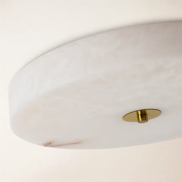 Close-up of polished white alabaster and the brass-finish centre cap