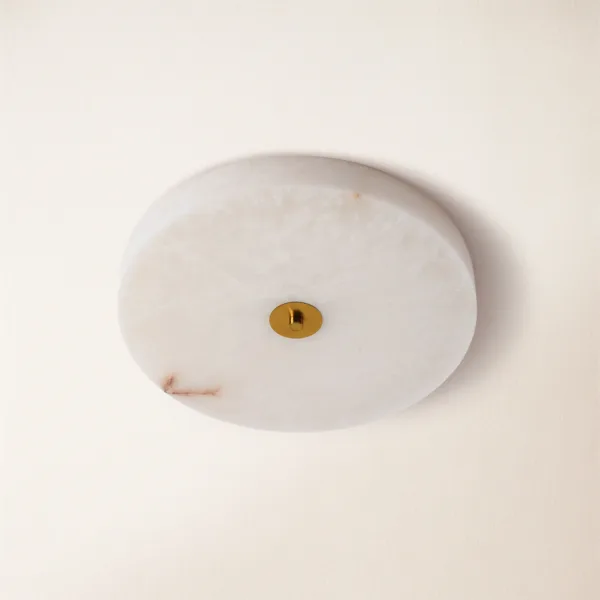 Unlit round alabaster disc ceiling light showing natural white stone