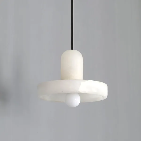 Alabaster disc pendant light showing the soft white cloud veining of the natural stone