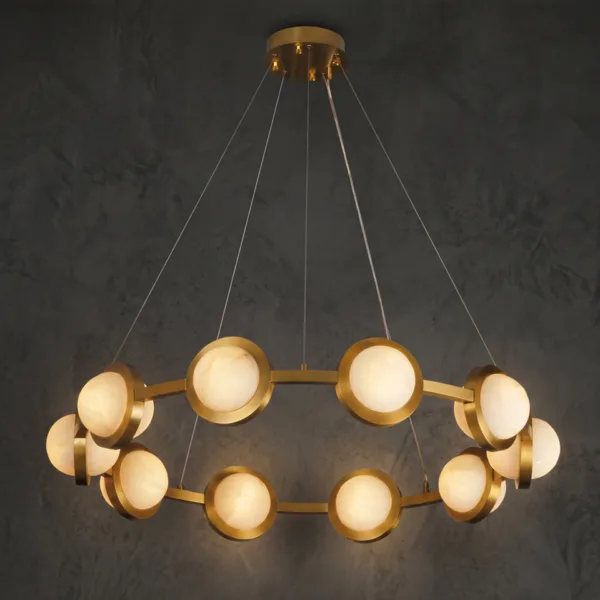 Alabaster disc ring chandelier lit, glowing against a dark wall