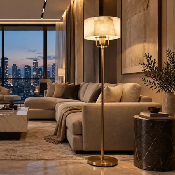 Alabaster drum floor lamp beside a beige sofa with a city view at night