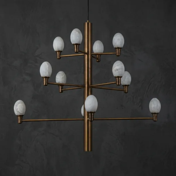 Alabaster egg chandelier with twelve egg-shaped alabaster shades on a brushed brass stem, unlit, on a dark wall
