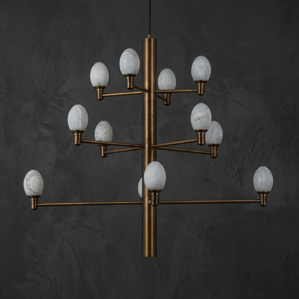 Alabaster egg chandelier with twelve egg-shaped alabaster shades on a brushed brass stem, unlit, on a dark wall