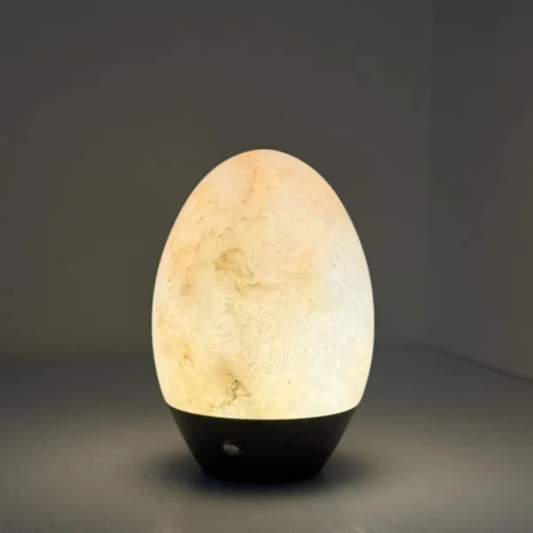 Alabaster egg night light glowing in a dim room