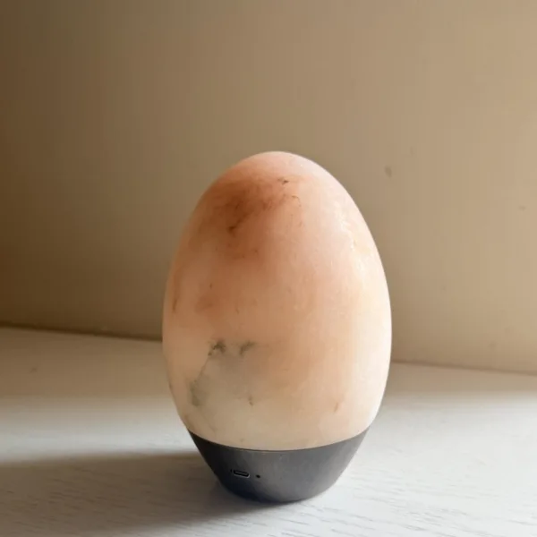 Unlit alabaster egg lamp showing blush and grey veining in the stone