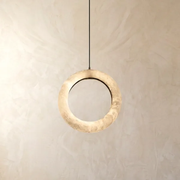 Alabaster halo ring pendant light glowing softly with built-in LED against a plaster wall